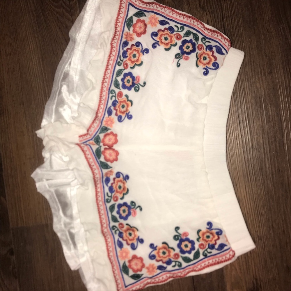 white and multiple colored flower shorts